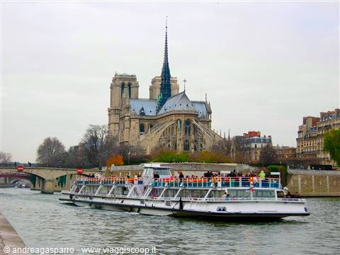 Tour boat on the Seine river in front of Notre-Dame cathedral, Paris
