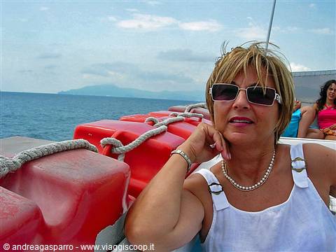 Woman with sunglasses on a boat, red buoys and rope, open sea