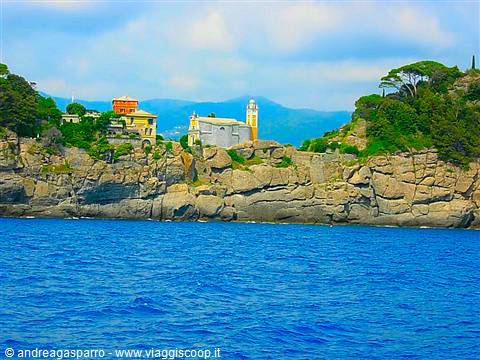 San Giorgio church on rocky cliff, Portofino, blue sea and colorful houses