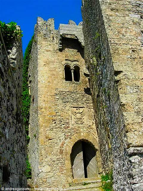 Medieval stone tower with wooden gate and carved eagle, Erice castle