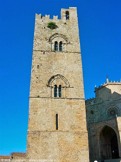 Medieval stone bell tower of Erice against deep blue sky