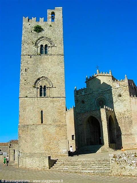 Stone bell tower and cathedral in Erice, tourists under a blue sky