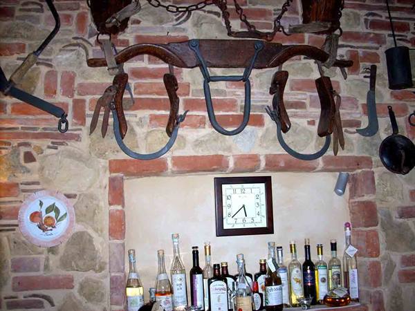 Old farming tools on the walls of the Trattoria La Serignola