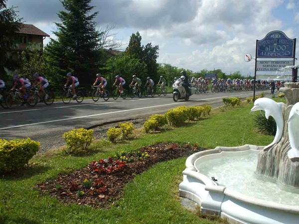 A cycling race in front of the Albergo Ristorante Al 700 of Cassano Spinola