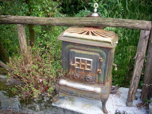 An old stove displayed along a path