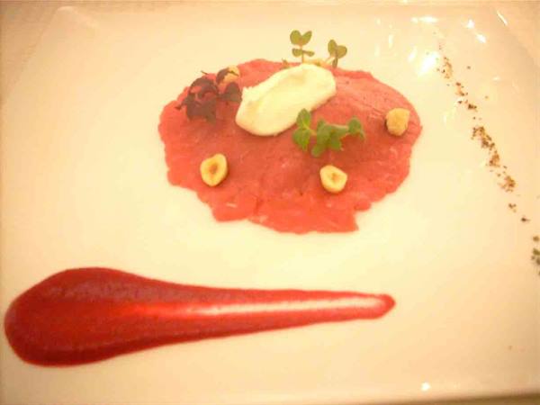 Delicacies of Il Convito della Venaria: Beef tartare with red beets, creamy goat cheese and peppers