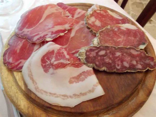 A cutting board of cured meats from Ristorante della Posta