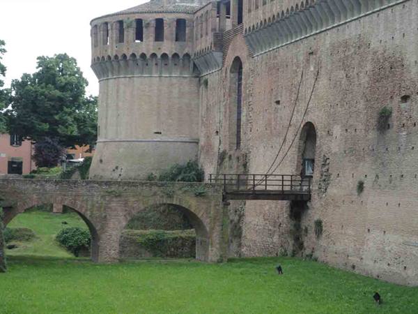 Brick round tower and stone bridge at Imola fortress