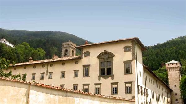 Vallombrosa Abbey, pale stone facade among green woods and mountains