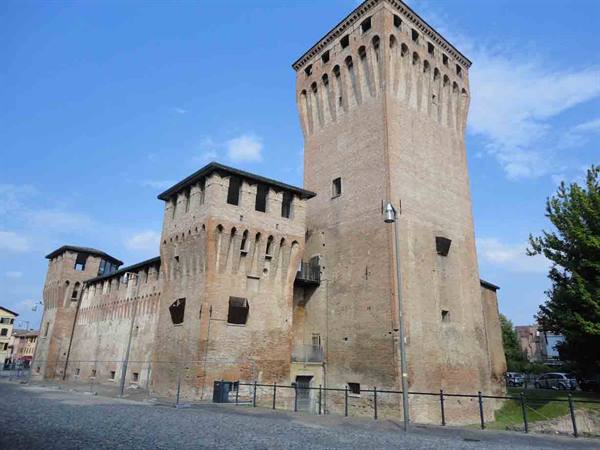 Rocca di Cento, brick tower with Guelph battlements under blue sky