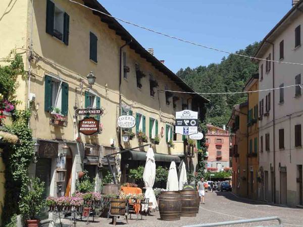 Village street with taverns, flowers and barrels under the sun