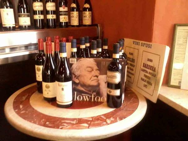 Wine bottles on marble table, bulk wine sign and wine shop display