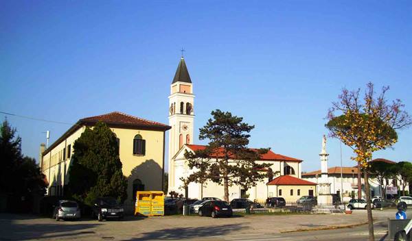 White church with bell tower in sunny square
