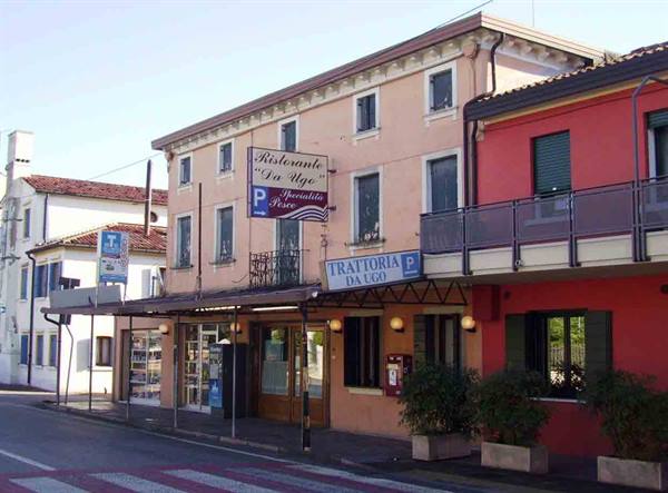 Trattoria Da Ugo in colorful buildings along the street
