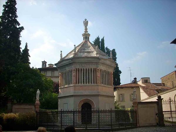 The octagonal marble Baptistery of Bergamo behind a wrought iron fence