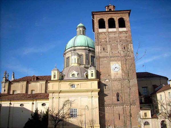 Vercelli Cathedral: green copper dome and brick bell tower with clock