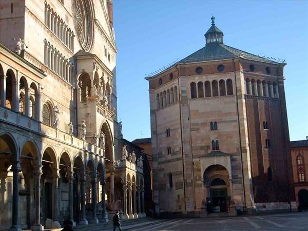 Cremona cathedral with the octagonal marble baptistery under the sun