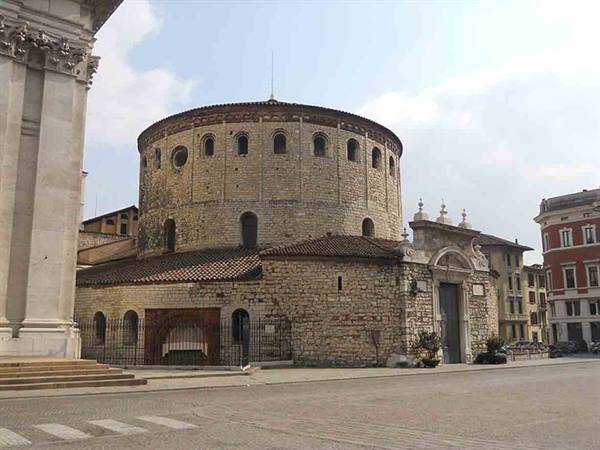 The round Old Cathedral in Brescia, stone walls beside the new duomo