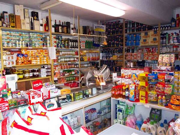 Inside a small grocery shop crowded with wine, preserves and detergents