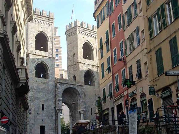Porta Soprana in Genoa: medieval stone towers among colorful buildings