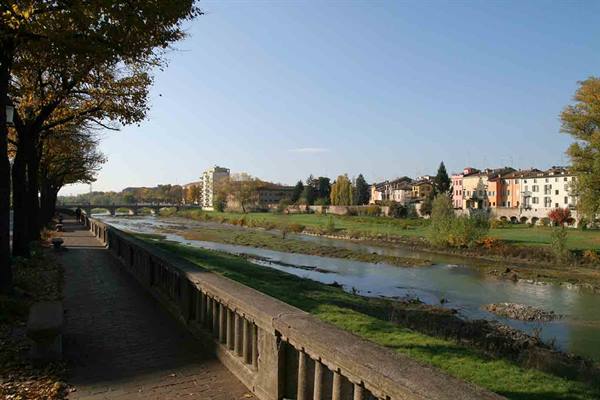 Along the Adige in Verona, stone parapet and colorful houses