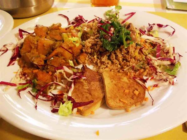 White plate with couscous, grilled tofu, vegetables and radicchio salad