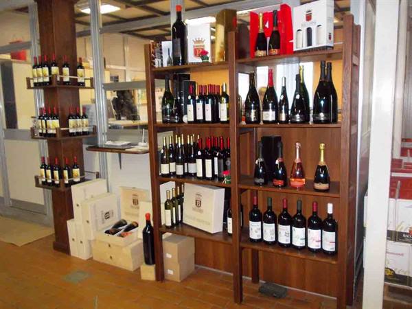 Wooden shelves full of wine bottles in a wine shop