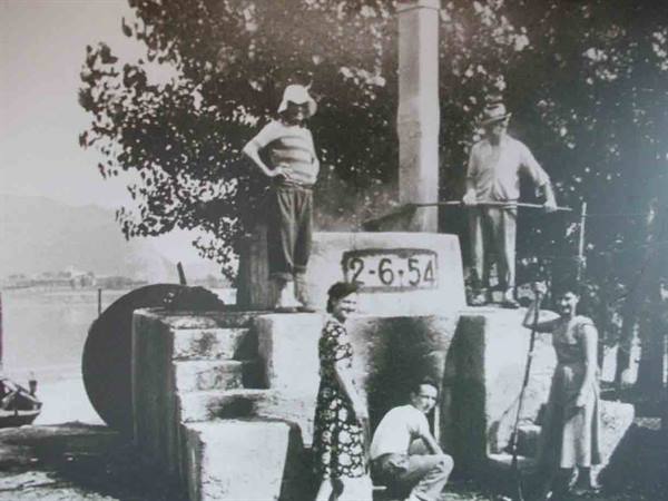 Group of people on stone structure dated 2-6-54, vintage photo