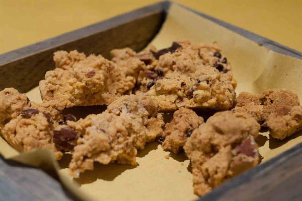 Chocolate chip cookies on parchment paper in a wooden box