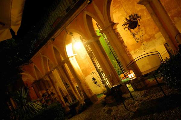 Arched colonnade lit by lanterns at night