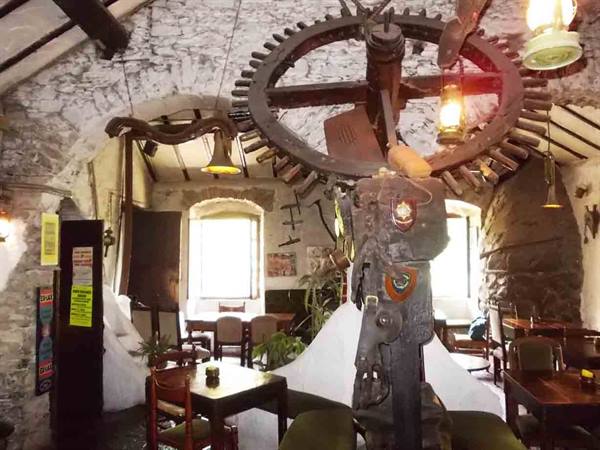 Ancient wooden mill gear inside an old mill now a rustic tavern