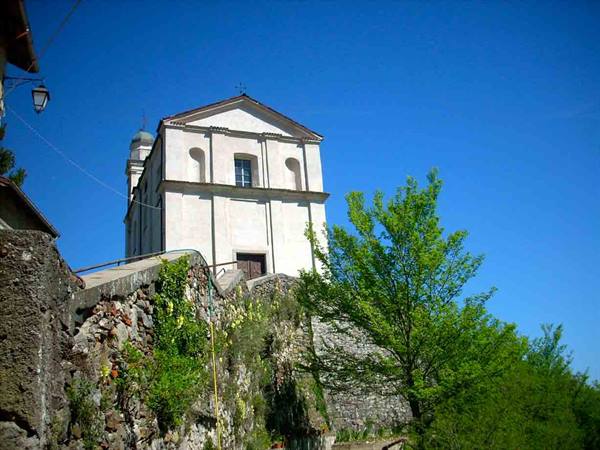 White church atop a stone staircase under a clear blue sky