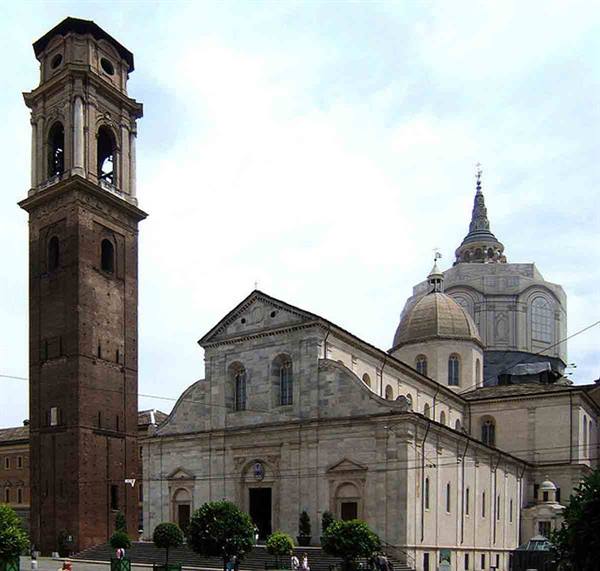 Turin Cathedral with its brick bell tower and dome under cloudy sky