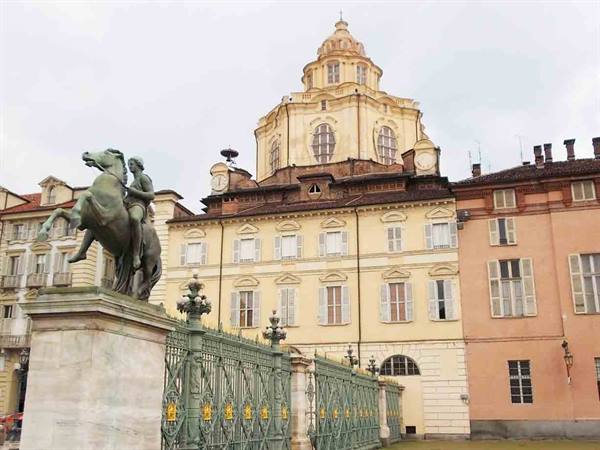 Bronze equestrian statue before the green gates of Palazzo Reale, Turin