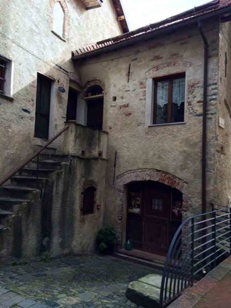 External stone staircase on old house with arched doorway