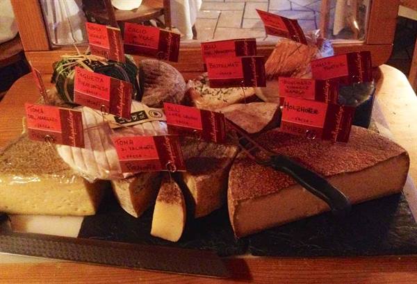 Cheese board with red labels and a cheese knife