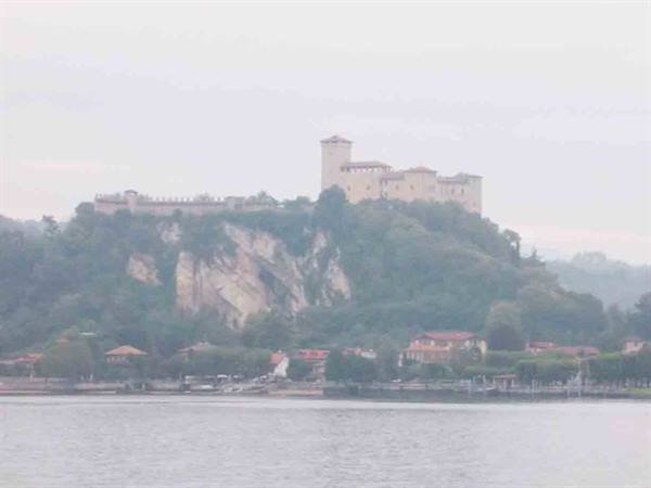 Rocca di Angera fortress on the cliff above Lake Maggiore in haze