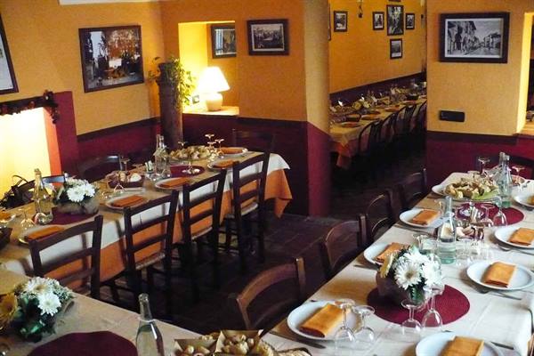 Restaurant dining room set with tablecloths, flowers and wooden chairs