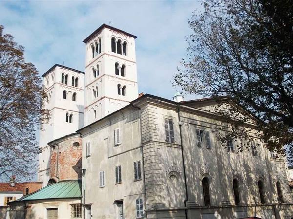 The twin Romanesque towers of Sant'Andrea in Vercelli above the buildings