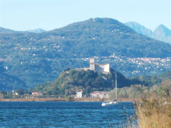Rocca di Angera fortress above Lake Maggiore, a sailboat on the water
