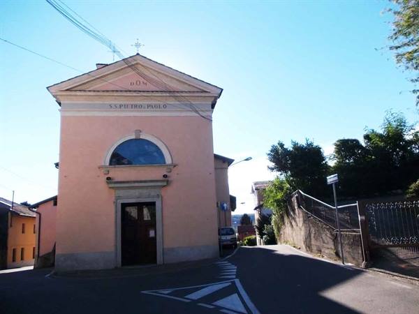 Pink church of S.S. Pietro e Paolo on a village road