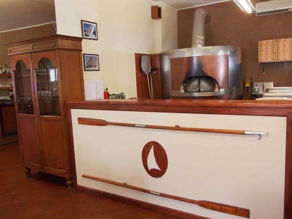 Wooden counter with decorative oars and metal dome pizza oven