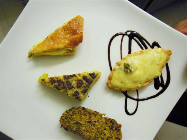White plate with frittata slice, veggie ball and chocolate-drizzled pastry