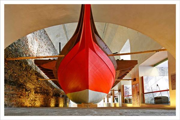 Red prow of a galley ship displayed at Barcelona Maritime Museum