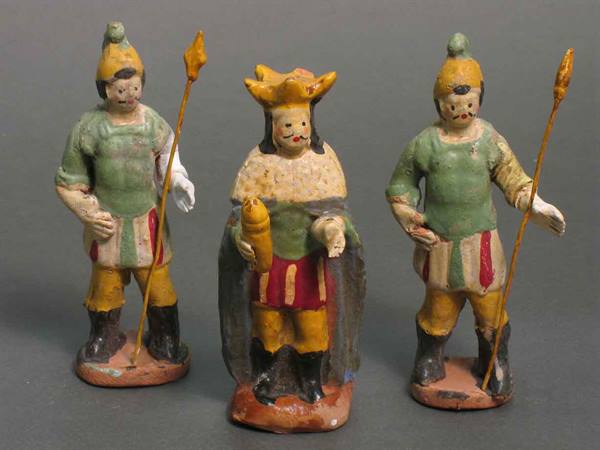 Three painted terracotta nativity figurines, Magi kings with spears, soft light