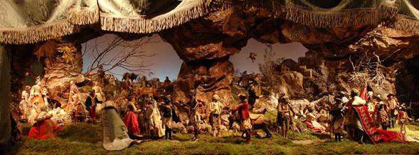 Neapolitan nativity scene with figurines among rocks and costumed figures