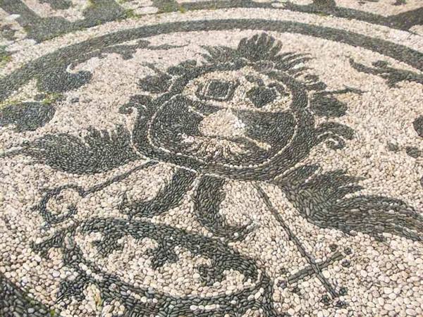 Pebble mosaic of white and black stones with a grotesque figure, typical of Rhodes