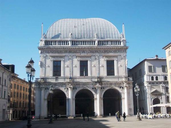 Palazzo della Loggia in Brescia, white stone facade under clear blue sky