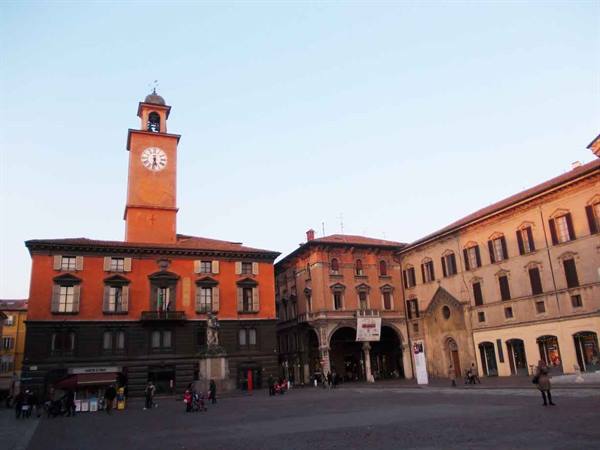 Piazza Grande in Reggio Emilia, clock tower glowing at dusk