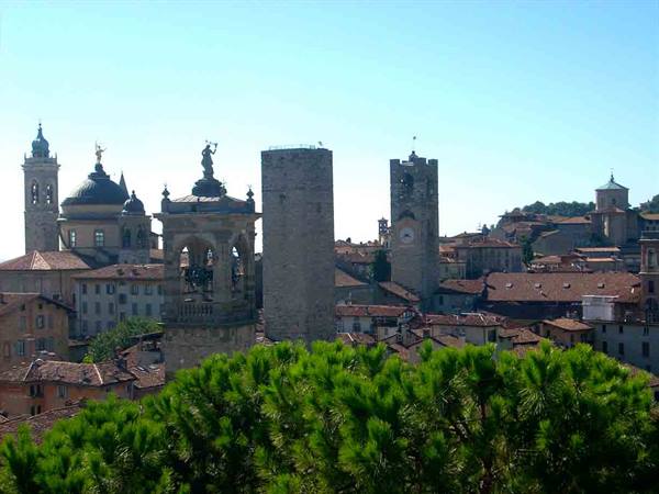 Medieval towers and rooftops of Bergamo Alta among bell towers and domes